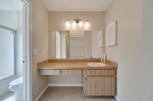 full bath with vanity, toilet, and baseboards