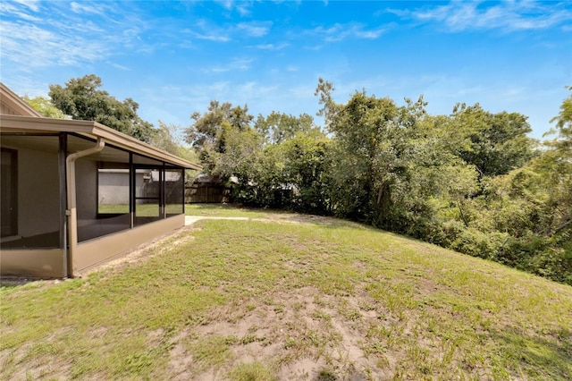 view of yard with a sunroom and fence