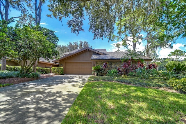 ranch-style home featuring a garage and a front yard