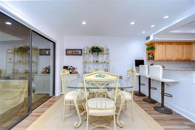 dining area with light hardwood / wood-style flooring