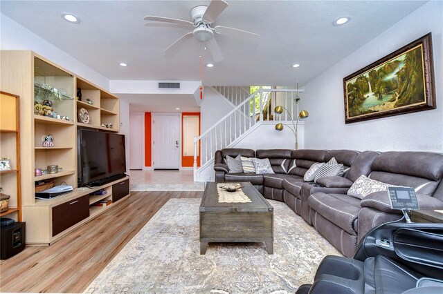 living room featuring ceiling fan and light wood-type flooring