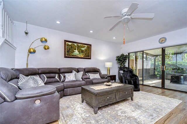 living room featuring a wealth of natural light, ceiling fan, and light wood-type flooring