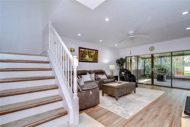 living room with light hardwood / wood-style floors and ceiling fan