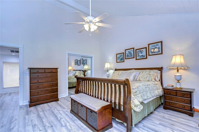 bedroom featuring light hardwood / wood-style flooring, ceiling fan, and high vaulted ceiling