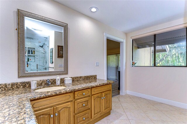 bathroom with vanity, tile patterned floors, and walk in shower