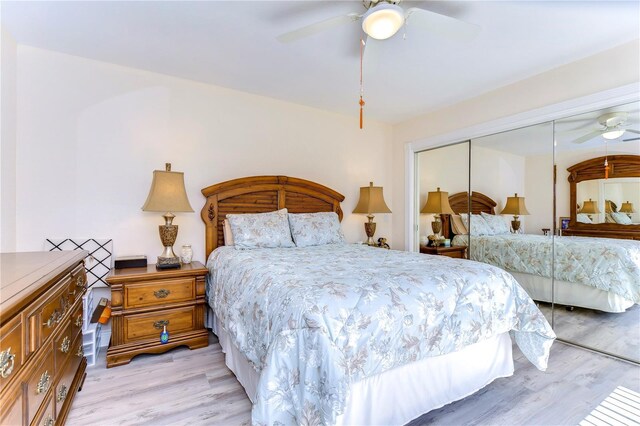 bedroom with a closet, light wood-type flooring, and ceiling fan