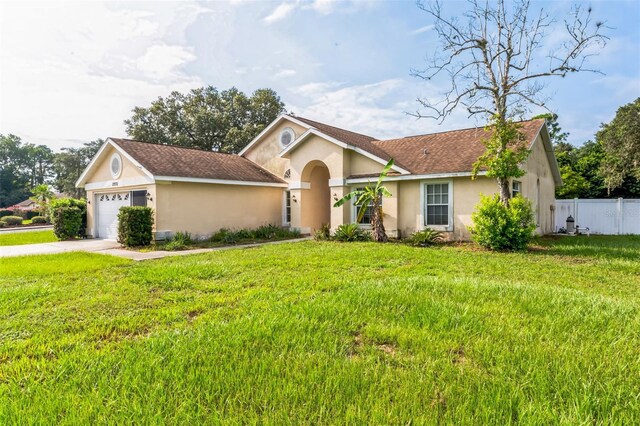 view of front of house with a garage and a front lawn