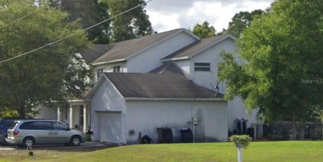 view of front of home with a front lawn and a garage