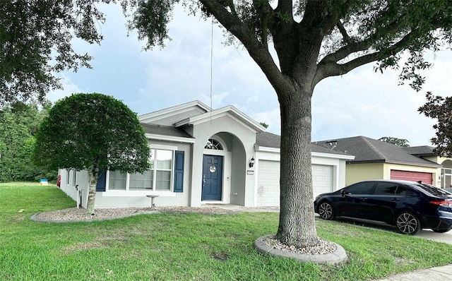 ranch-style house featuring a front lawn and a garage