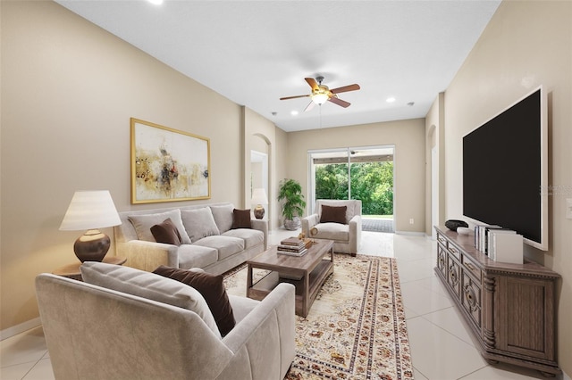 living room featuring light tile patterned floors and ceiling fan