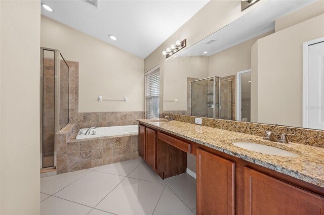 bathroom with double vanity, plus walk in shower, and tile patterned floors