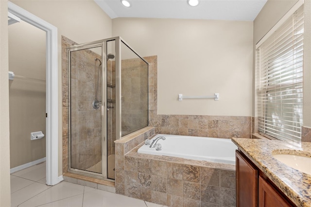 bathroom featuring vanity, shower with separate bathtub, lofted ceiling, and tile patterned floors