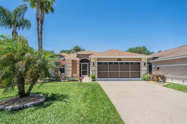 view of front facade with a front yard and a garage