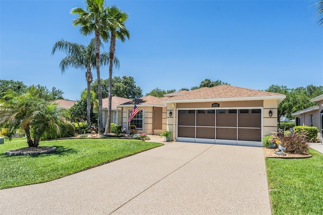 single story home featuring a garage and a front lawn