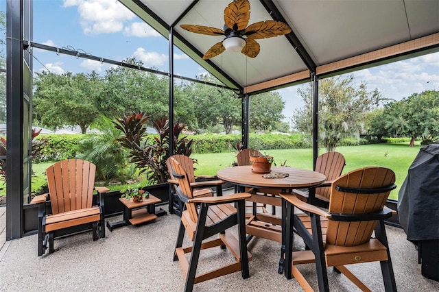 sunroom / solarium with ceiling fan and lofted ceiling