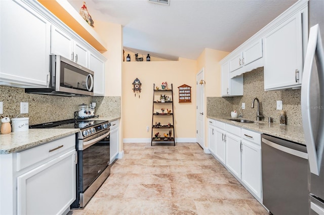 kitchen featuring sink, stainless steel appliances, light tile patterned flooring, and tasteful backsplash