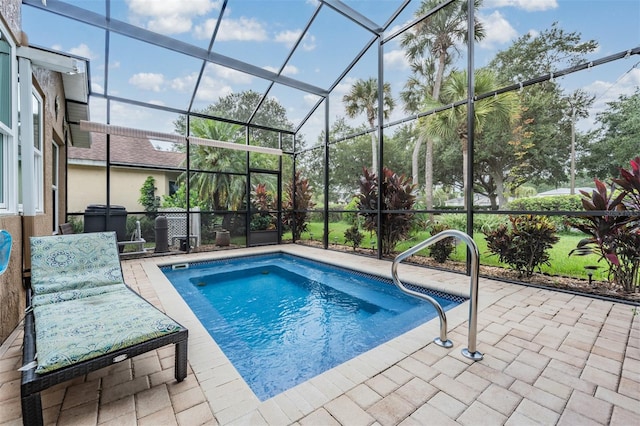 view of pool featuring a patio and glass enclosure