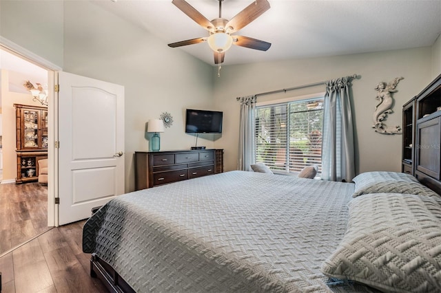 bedroom with ceiling fan, vaulted ceiling, and wood-type flooring