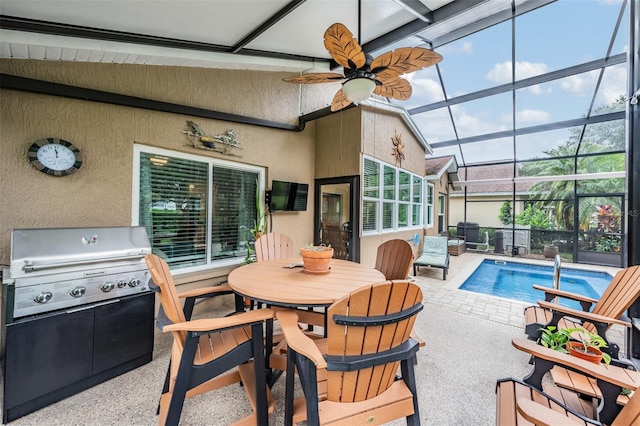 sunroom / solarium featuring ceiling fan and lofted ceiling