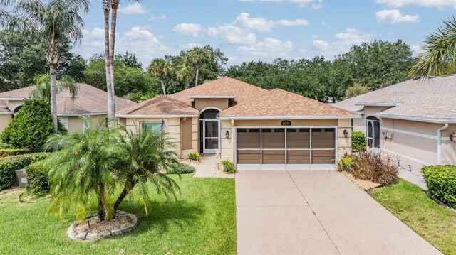 view of front of property featuring a garage and a front lawn