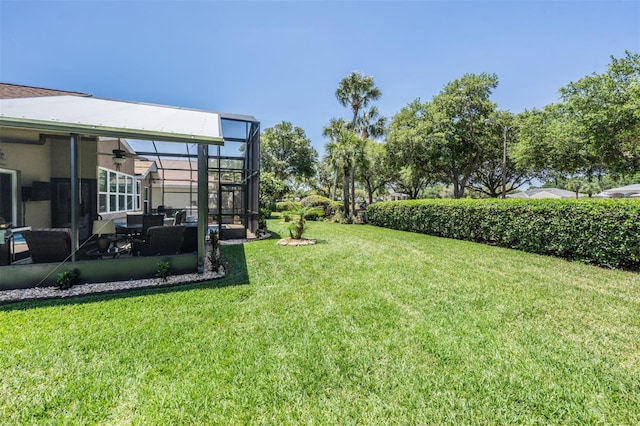 view of yard featuring glass enclosure