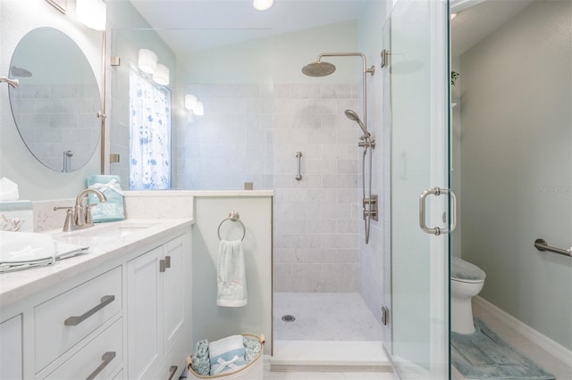 bathroom featuring dual vanity, toilet, tile patterned flooring, lofted ceiling, and a shower with shower door