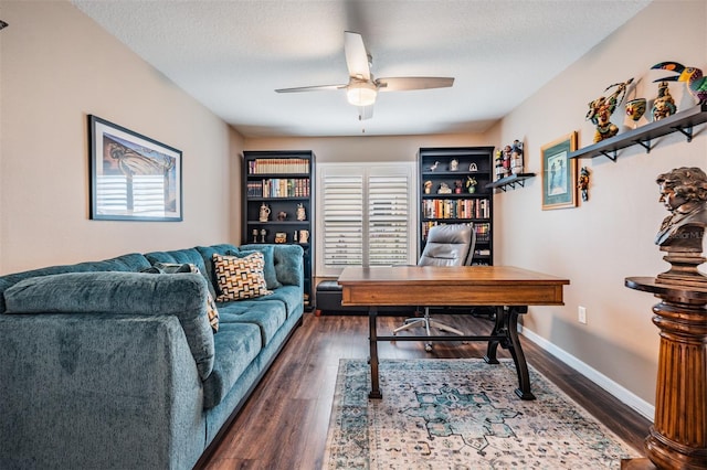 home office with a textured ceiling, ceiling fan, and dark hardwood / wood-style floors