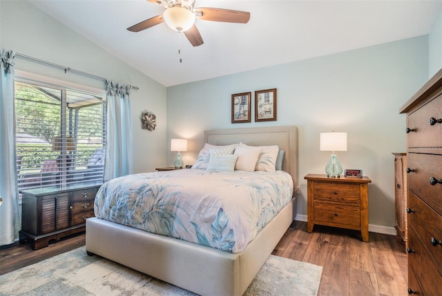 bedroom featuring hardwood / wood-style floors, vaulted ceiling, and ceiling fan