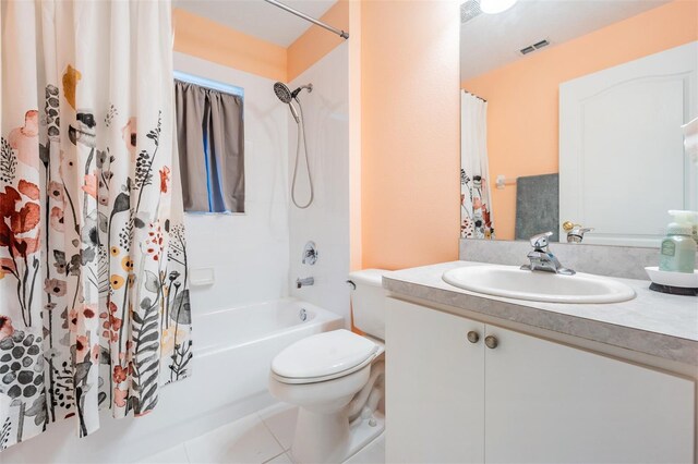 full bathroom with tile patterned floors, toilet, shower / bath combo with shower curtain, and vanity