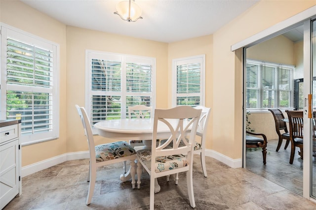 dining room featuring plenty of natural light and light tile patterned floors