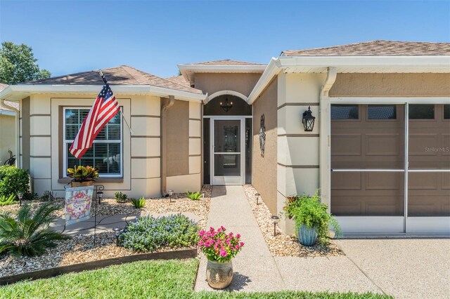 doorway to property with a garage