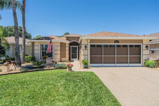 view of front of house featuring a garage and a front lawn