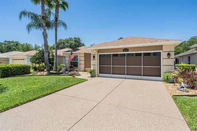 ranch-style home with a garage and a front lawn