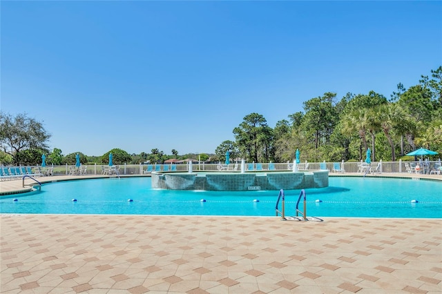 view of swimming pool with pool water feature