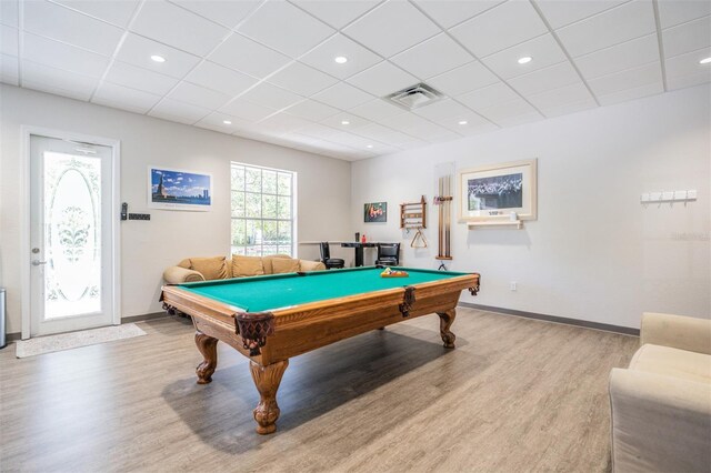 rec room with pool table, light hardwood / wood-style flooring, and a paneled ceiling