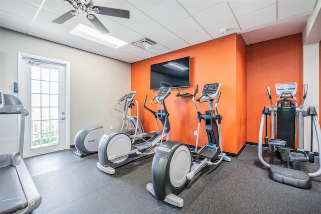 workout area featuring ceiling fan and a drop ceiling