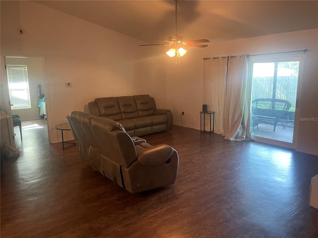 living room with dark wood-type flooring, ceiling fan, and lofted ceiling