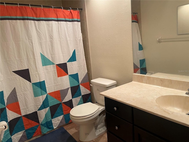 bathroom with vanity, toilet, and walk in shower