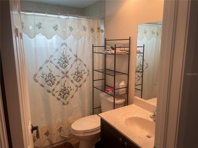 bathroom with vanity, toilet, and curtained shower