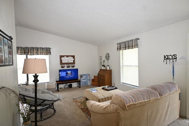 carpeted living room featuring vaulted ceiling