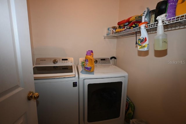 clothes washing area featuring independent washer and dryer