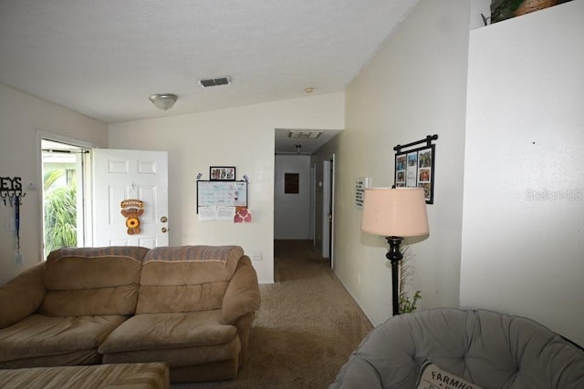 carpeted living room featuring vaulted ceiling