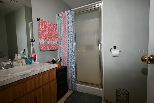 bathroom featuring vanity and curtained shower