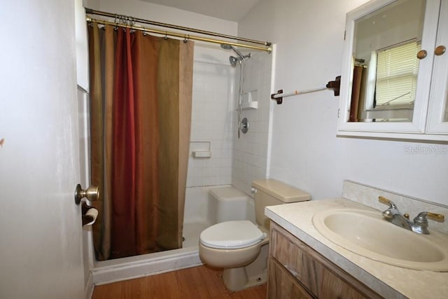 bathroom featuring toilet, hardwood / wood-style floors, vanity, and a shower with curtain