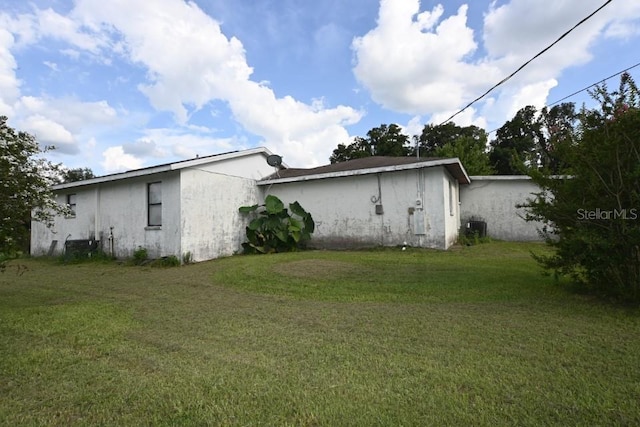 view of home's exterior featuring central AC and a lawn