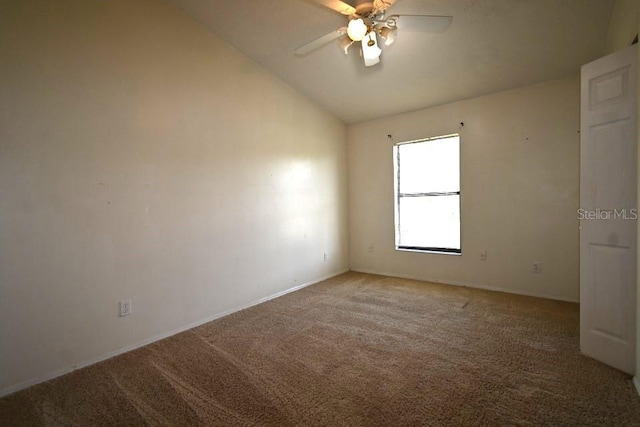 carpeted empty room featuring lofted ceiling and ceiling fan