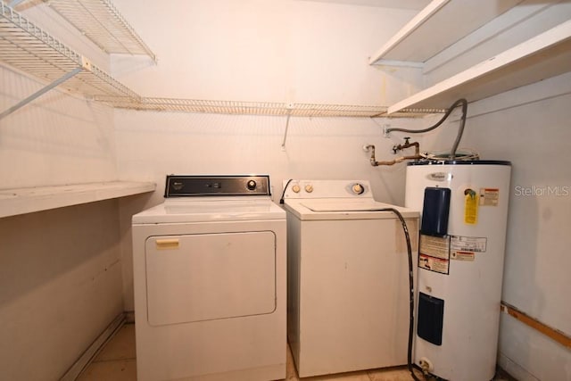 clothes washing area with water heater, laundry area, and separate washer and dryer