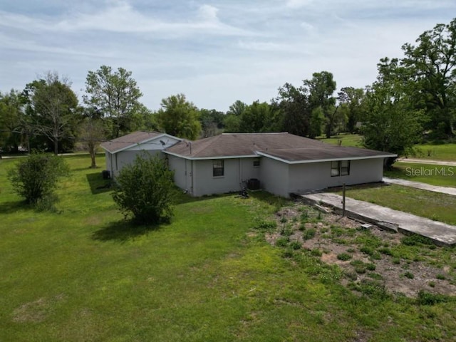 rear view of house with a yard