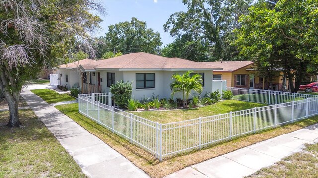 ranch-style home with a front lawn