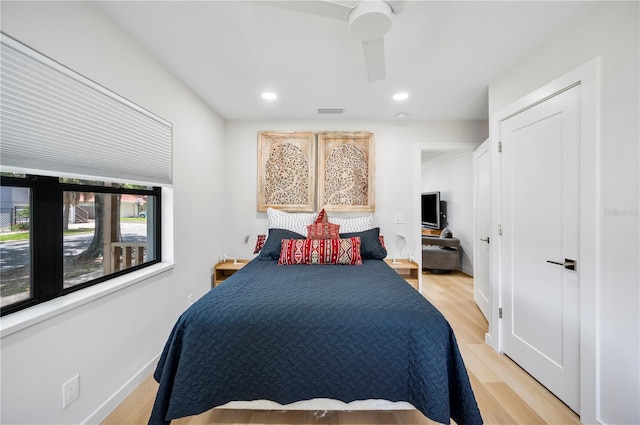 bedroom featuring light hardwood / wood-style flooring and ceiling fan